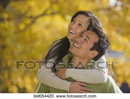 Asian woman hugging boyfriend View Large Photo Image Stock Image - Asian woman hugging boyfriend. Fotosearch