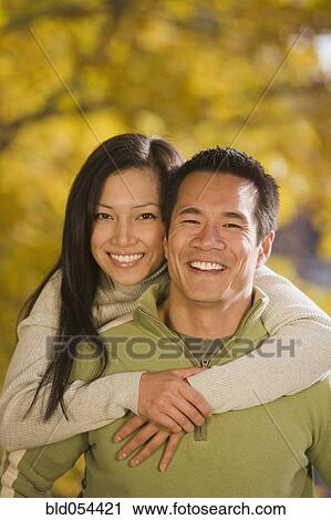 Asian woman hugging boyfriend View Large Photo Image Stock Image - Asian woman hugging boyfriend. Fotosearch