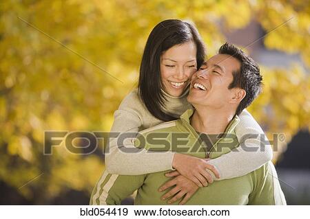 Asian woman hugging boyfriend View Large Photo Image Stock Photo - Asian woman hugging boyfriend. Fotosearch