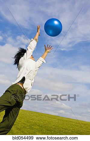 Asian woman jumping for ball View Large Photo Image Stock Photo - Asian woman jumping for ball. Fotosearch
