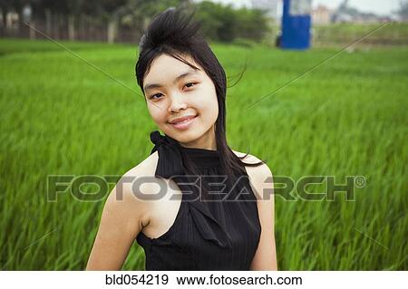 Stock Photo - Asian woman with hair blowing. Fotosearch
