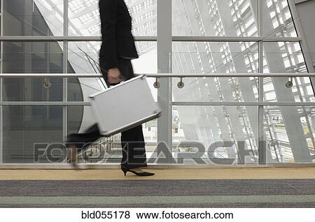 Stock Photo - Businesswoman carrying briefcase. Fotosearch