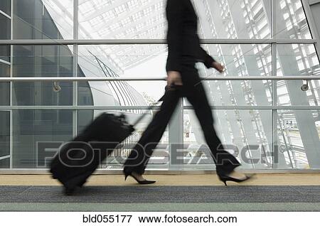 Businesswoman pulling suitcase View Large Photo Image Stock Photo - Businesswoman pulling suitcase. Fotosearch