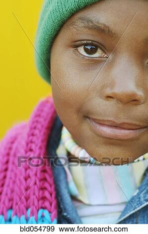 Stock Photo - Close up of African girl wearing winter hat. Fotosearch