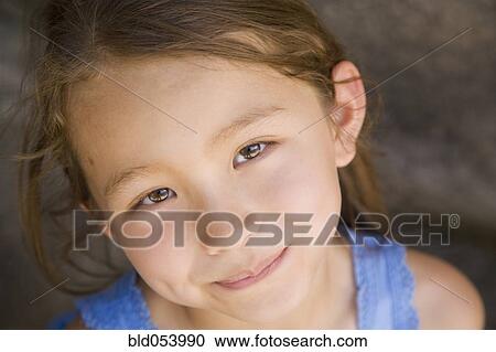 Stock Image - Close up of Asian girl smiling. Fotosearch
