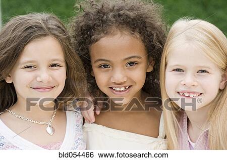 Close up of multi-ethnic girls smiling View Large Photo Image Stock Photograph - Close up of multi-ethnic girls smiling. Fotosearch
