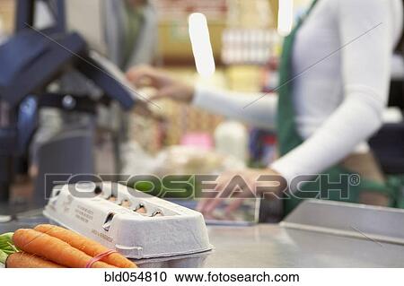 Stock Image - Groceries on check out counter. Fotosearch