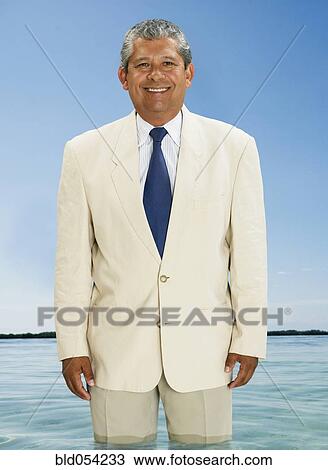 Hispanic businessman standing in water View Large Photo Image Stock Image - Hispanic businessman standing in water. Fotosearch