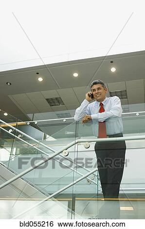 Hispanic businessman talking on cell phone View Large Photo Image Stock Photograph - Hispanic businessman talking on cell phone. Fotosearch