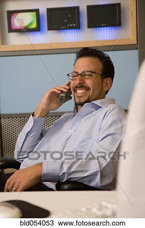 Hispanic businessman talking on telephone View Large Photo Image Stock Image - Hispanic businessman talking on telephone. Fotosearch