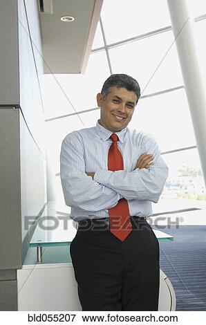 Hispanic businessman with arms crossed View Large Photo Image Stock Photo - Hispanic businessman with arms crossed. Fotosearch