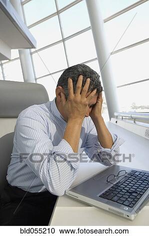 Hispanic businessman with head in hands View Large Photo Image Stock Image - Hispanic businessman with head in hands. Fotosearch
