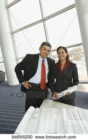 Hispanic businesspeople next to blueprints View Large Photo Image Stock Image - Hispanic businesspeople next to blueprints. Fotosearch