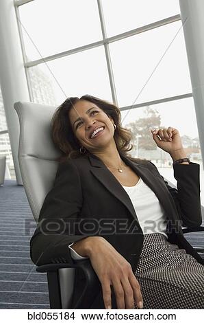 Hispanic businesswoman sitting in chair View Large Photo Image Picture - Hispanic businesswoman sitting in chair. Fotosearch
