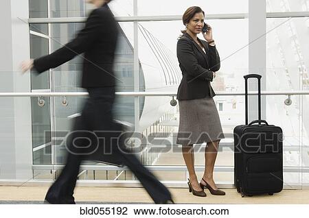Stock Image - Hispanic businesswoman talking on cell phone. Fotosearch