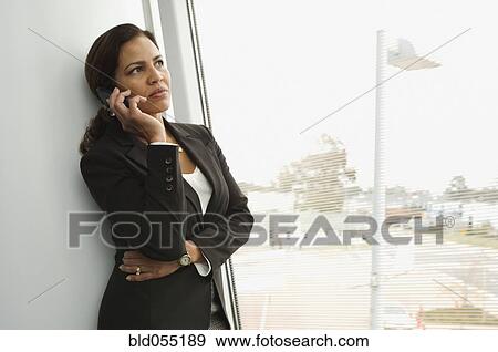 Hispanic businesswoman talking on cell phone View Large Photo Image Stock Photo - Hispanic businesswoman talking on cell phone. Fotosearch