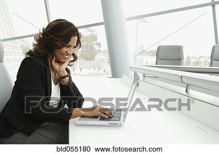 Hispanic businesswoman typing on laptop View Large Photo Image Stock Image - Hispanic businesswoman typing on laptop. Fotosearch