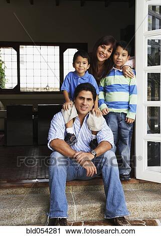 Hispanic family hugging in doorway View Large Photo Image Stock Image - Hispanic family hugging in doorway. Fotosearch