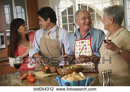 Stock Image - Hispanic family preparing food. Fotosearch