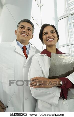 Hispanic male and female doctors with chart View Large Photo Image Stock Image - Hispanic male and female doctors with chart. Fotosearch