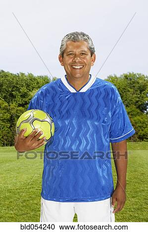 Hispanic man holding soccer ball View Large Photo Image Stock Image - Hispanic man holding soccer ball. Fotosearch
