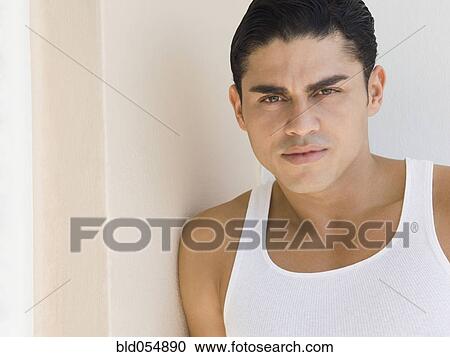 Hispanic man leaning on wall View Large Photo Image Stock Image - Hispanic man leaning on wall. Fotosearch