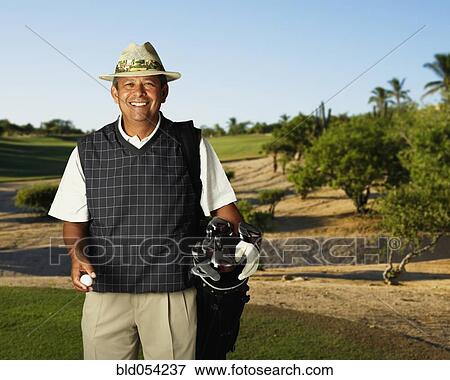 Hispanic man on golf course View Large Photo Image Stock Photo - Hispanic man on golf course. Fotosearch