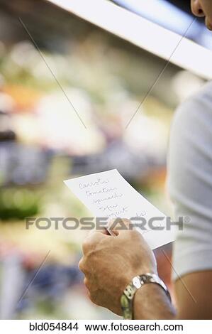 Hispanic man reading grocery list View Large Photo Image Picture - Hispanic man reading grocery list. Fotosearch