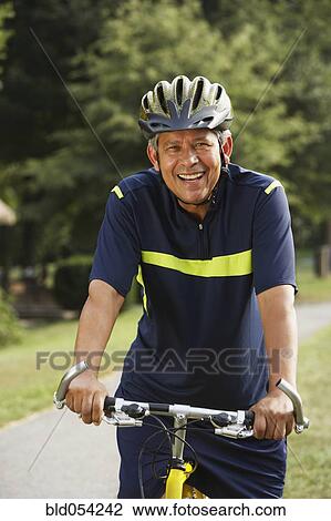 Hispanic man riding bicycle View Large Photo Image Stock Image - Hispanic man riding bicycle. Fotosearch