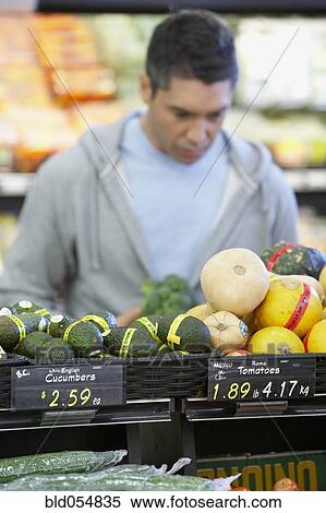 Stock Photography - Hispanic man shopping for produce. Fotosearch