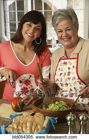Hispanic mother and adult daughter preparing food View Large Photo Image Stock Photography - Hispanic mother and adult daughter preparing food. Fotosearch