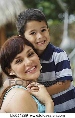 Hispanic mother and son hugging View Large Photo Image Stock Photo - Hispanic mother and son hugging. Fotosearch