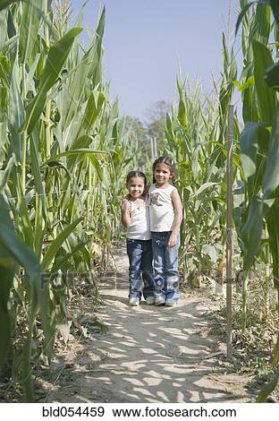 Stock Photo - Hispanic sisters in corn field. Fotosearch
