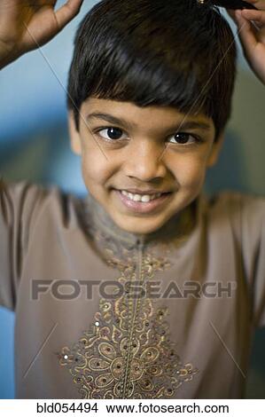 Picture - Indian boy with hands over head. Fotosearch
