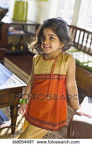 Indian girl standing in livingroom View Large Photo Image Stock Image - Indian girl standing in livingroom. Fotosearch