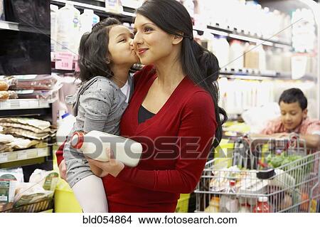Picture - Indian mother grocery shopping with children. Fotosearch