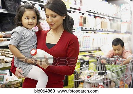 Indian mother grocery shopping with children View Large Photo Image Stock Image - Indian mother grocery shopping with children. Fotosearch