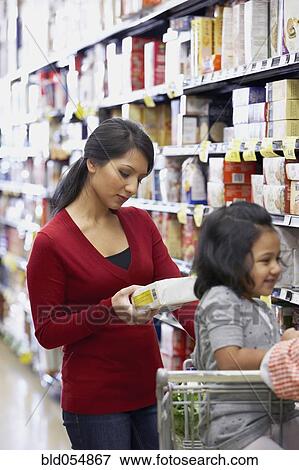 Indian mother shopping in grocery store View Large Photo Image Stock Photo - Indian mother shopping in grocery store. Fotosearch