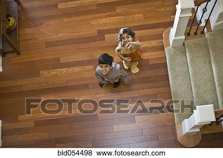Stock Photo - Indian sister and brother looking up. Fotosearch
