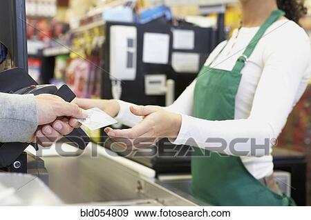 Man paying with credit card at grocery store View Large Photo Image Stock Photo - Man paying with credit card at grocery store. Fotosearch