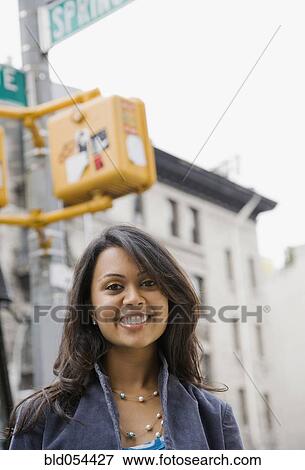 Mixed Race woman under street sign View Large Photo Image Stock Photo - Mixed Race woman under street sign. Fotosearch