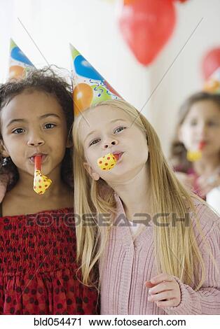 Stock Image - Multi-ethnic girls at birthday party. Fotosearch