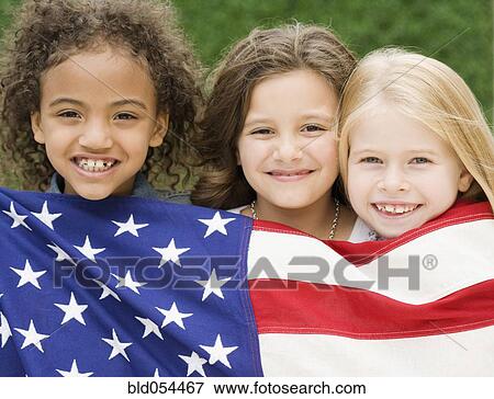 Stock Photo - Multi-ethnic girls holding American flag. Fotosearch