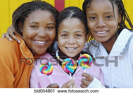 Multi-ethnic girls holding lollipops View Large Photo Image Stock Image - Multi-ethnic girls holding lollipops. Fotosearch