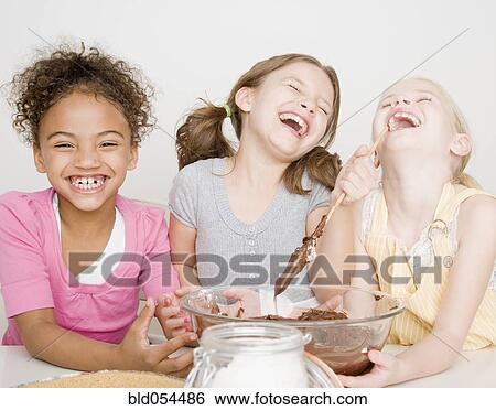 Multi-ethnic girls making batter View Large Photo Image Stock Photograph - Multi-ethnic girls making batter. Fotosearch