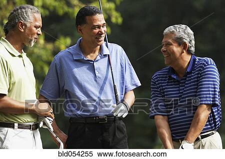 Stock Photography - Multi-ethnic men holding golf clubs. Fotosearch