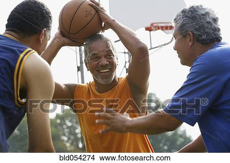 Multi-ethnic men playing basketball View Large Photo Image Picture - Multi-ethnic men playing basketball. Fotosearch