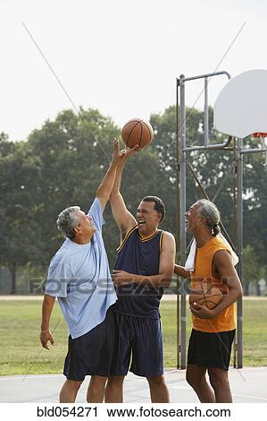 Multi-ethnic men playing basketball View Large Photo Image Stock Image - Multi-ethnic men playing basketball. Fotosearch