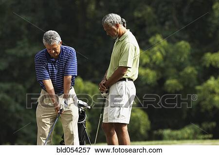 Multi-ethnic men playing golf View Large Photo Image Stock Photo - Multi-ethnic men playing golf. Fotosearch
