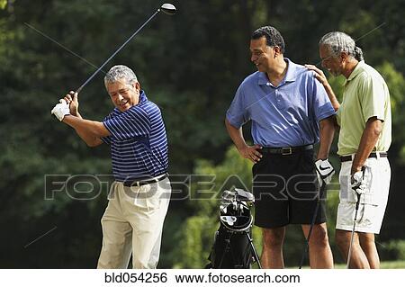 Stock Photograph - Multi-ethnic men playing golf. Fotosearch